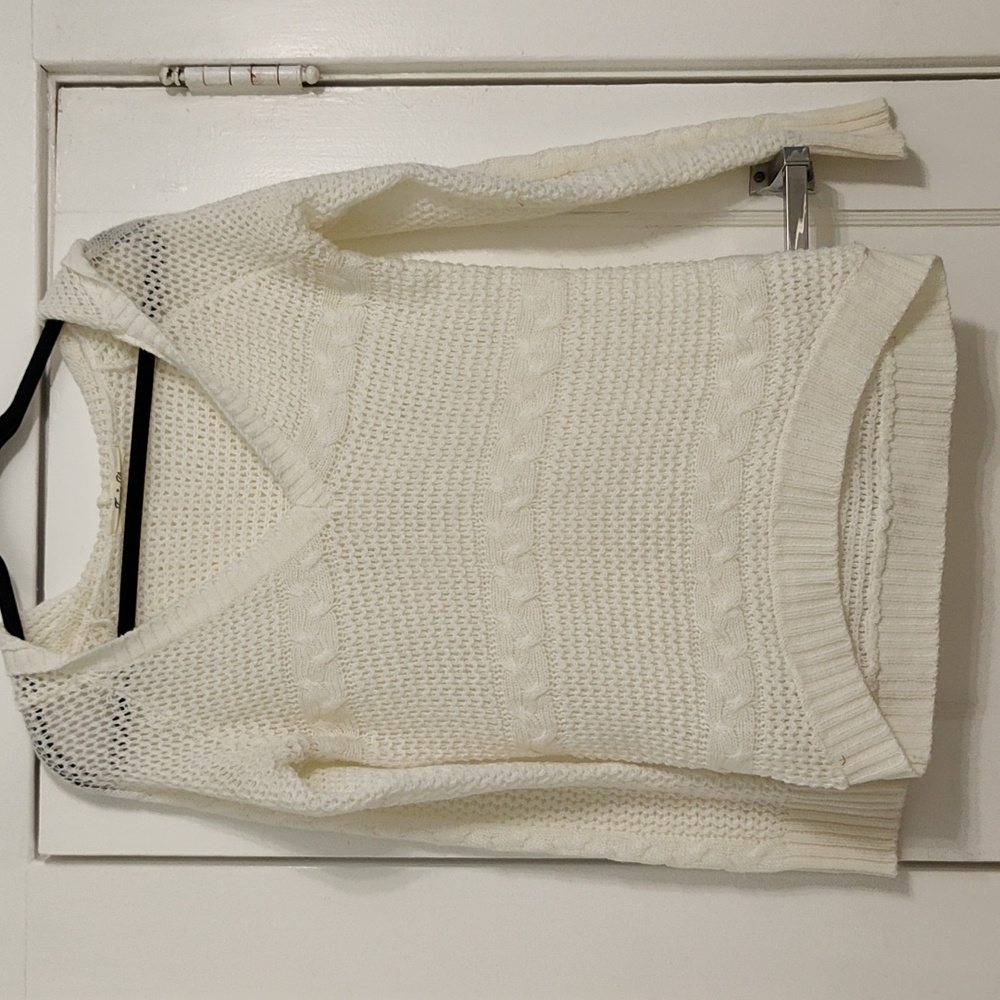 Cream colored open weave hooded sweater.